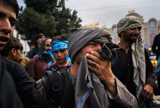 A man cries as he watches fellow Afghans get wounded after Taliban fighters use guns fire, whips, sticks and sharp objects to maintain crowd control over thousands of Afghans who continue to wait outside the Kabul Airport for a way out, on airport road in Kabul, Afghanistan, Tuesday, August 17, 2021. At least half dozen were wounded, within the hour of violent escalation, including a woman and her child. (Photo by Marcus Yam/Los Angeles Times/Rex Features/Shutterstock)