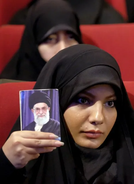 A woman holds a picture of Iran's Supreme Leader Ayatollah Ali Khamenei during a conservatives campaign gathering for the upcoming parliamentary elections and the upcoming vote on the Assembly of Experts, in Tehran February 24, 2016. The campaign gathering was titled “No to UK Meddling”. (Photo by Raheb Homavandi/Reuters/TIMA)