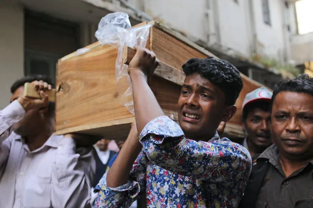 A Bangladeshi boy cries as he carries the coffin of a relative who died in a fire in Dhaka, Bangladesh, Thursday, February 21, 2019. (Photo by Rehman Asad/AP Photo)
