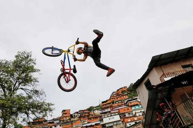 Venezuelan BMX Freestyle Daniel Dhers, Olympic silver medalist in Tokyo, performs an exhibition in the popular neighborhood of Cota 905 in Caracas, Venezuela on August 14, 2021. (Photo by Leonardo Fernandez/Reuters)