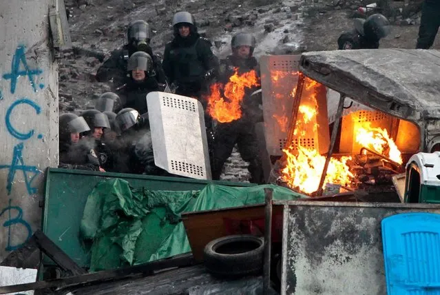 Protesters clash with police in central Kiev, Ukraine, Monday, January 20, 2014. (Photo by Sergei Chuzavkov/AP Photo)