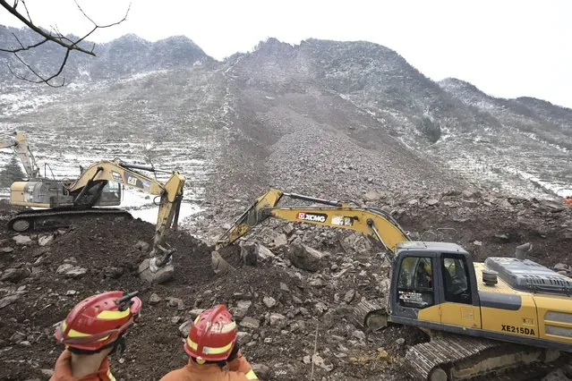 In this photo released by Xinhua News Agency, rescue workers look on as excavators dig at the site of a landslide in Liangshui village, Tangfang Town in the city of Zhaotong in southwestern China's Yunnan Province, Monday January 22, 2024. The landslide in southwestern China's mountainous Yunnan province early Monday buried dozens and forced the evacuation of hundreds (Photo by Yue Yuewei/Xinhua via AP Photo)
