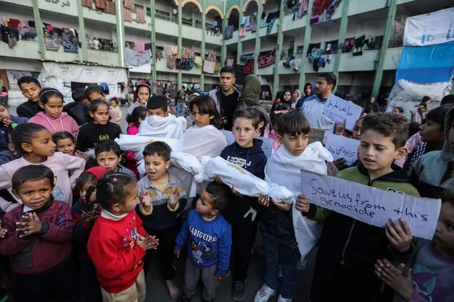 Palestinian children march during a protest demanding an end to the war and their right to live, education and play on February 14, 2024 in Rafah, Gaza. Strikes intensified overnight as Israel reiterated intent to press on with a ground offensive in Gaza's southern city of Rafah where some 1.4 million internally displaced Palestinians are sheltering, whilst a growing number of countries express alarm over the operation. (Photo by Ahmad Hasaballah/Getty Images)