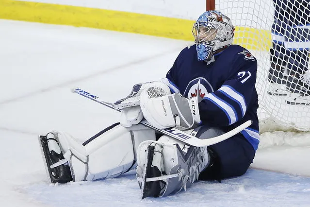 Winnipeg Jets goaltender Connor Hellebuyck reacts after St. Louis Blues' Jaden Schwartz scored in the final minute of Game 5 of an NHL hockey first-round playoff series Thursday, April 18, 2019, in Winnipeg, Manitoba. (Photo by John Woods/The Canadian Press via AP Photo)