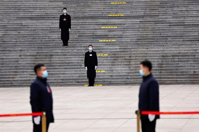 Security personnel stand guard, on the day of the opening session of the Chinese People's Political Consultative Conference (CPPCC), in front of the Great Hall of the People, in Beijing on March 4, 2024. (Photo by Tingshu Wang/Reuters)