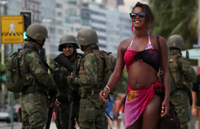 Brazilian navy soldiers patrol the area at the Copacabana Beach before carnival festivities in Rio de Janeiro, Brazil February 14, 2017. (Photo by Sergio Moraes/Reuters)