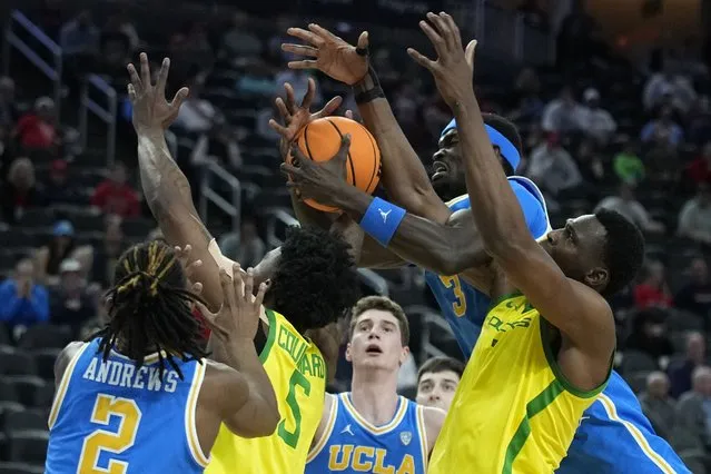 Oregon center N'Faly Dante, right, and UCLA forward Adem Bona (3) battle for a rebound during the second half of an NCAA college basketball game in the quarterfinal round of the Pac-12 tournament Thursday, March 14, 2024, in Las Vegas. (Photo by John Locher/AP Photo)