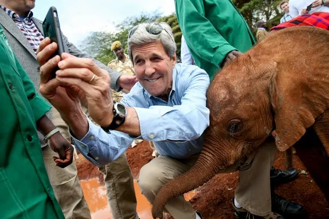 U.S. Secretary of State John Kerry takes a selfie with a baby elephant while touring the Sheldrick Center Elephant Orphanage at the Nairobi National Park, Sunday, May 3, 2015, in Nairobi, Kenya. (Photo by Andrew Harnik/Reuters)