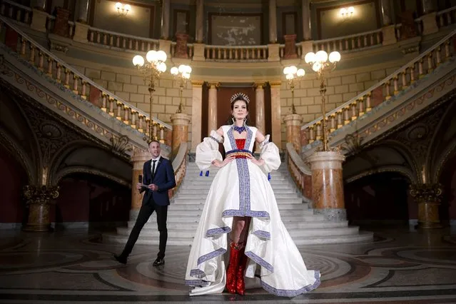 Miss Universe contestant Carmina Olimpia Cotfas of Romania poses dressed in the national costume for Miss Universe Romania 2021, created by Israeli designer Aviad Arik Herman, in the hallway of the Romanian Atheneum, the reputed 19th century built concert hall, in Bucharest, Romania, Monday, November 22, 2021. The 70th Miss Universe pageant is being staged in the southern Israeli resort city of Eilat on December 12. (Photo by Andreea Alexandru/AP Photo)