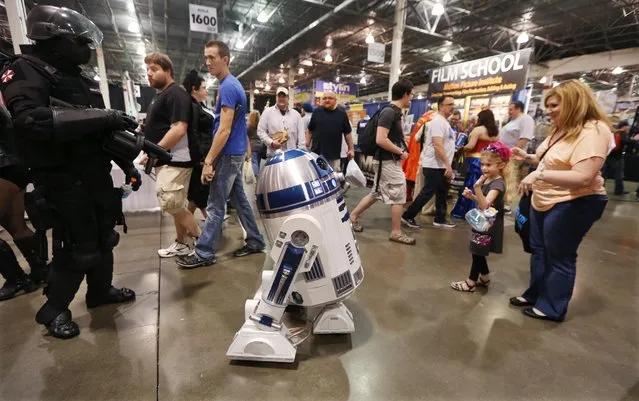 An R2-D2 droid tours the Motor City Comic Con at the Suburban Collection Showcase, Friday, May 15, 2015, in Novi, Mich. The three-day pop-culture extravaganza will welcome dozens of celebrities from the worlds of TV, film and beyond as well as thousands of fans. (AP Photo/Carlos Osorio)