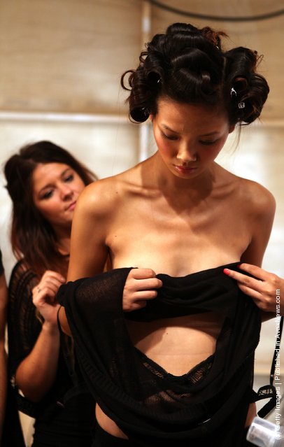 A model backstage before the Issa London runway show at London Fashion Week Spring/Summer 2012
