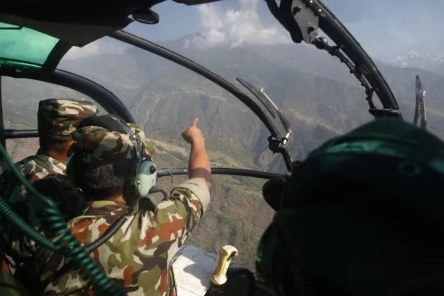 Nepalese army men search for the missing U.S. Marine helicopter in the earthquake affected Dolakha District, Nepal, Thursday, May 14, 2015. The helicopter carrying six Marines and two Nepalese soldiers disappeared Tuesday while delivering aid in the country's northeast, U.S. officials said. (Photo by Niranjan Shrestha/AP Photo)