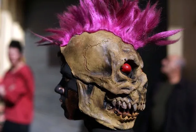 A Lebanese boy, wearing a mask, takes part in the Zambo carnival held in the northern Lebanese city of Tripoli on February 26, 2017, to mark the last period of excess on the eve of the Christian Greek Orthodox lent. The inspiration of the annual Zambo celebration is unclear, despite it being a tradition that stretches back over a century to when an emigrant to Brazil returned to his native Tripoli bringing the carnival with him. (Photo by Patrick Baz/AFP Photo)