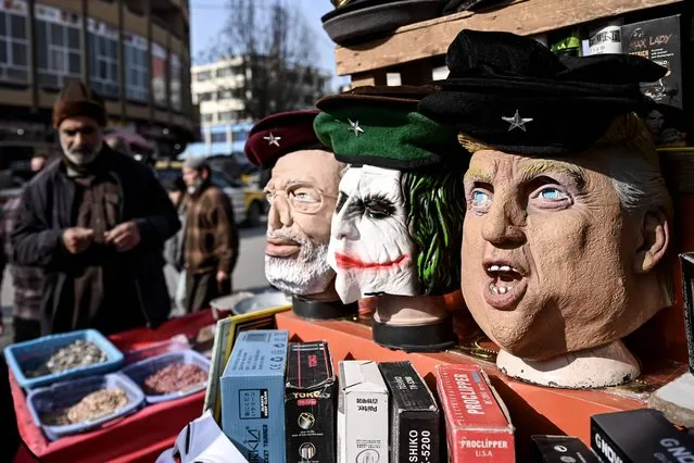 Masks resembling famous personalities and fictional characters are kept for sale at a shop in Kabul on December 29, 2021. (Photo by Mohd Rasfan/AFP Photo)