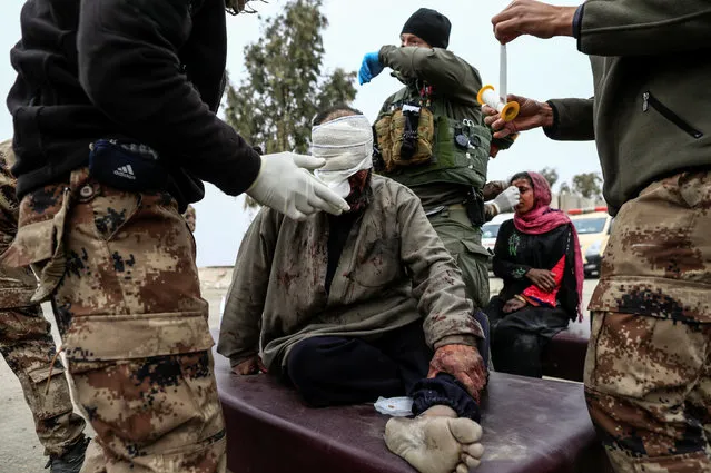 A man injured in a mortar attack is treated by medics in a field clinic as Iraqi forces battle with Islamic State militants, in western Mosul, Iraq March 2, 2017. (Photo by Zohra Bensemra/Reuters)