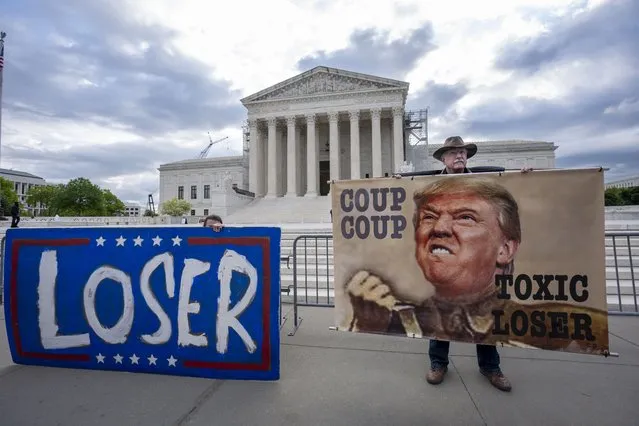 Activist Stephen Parlato of Boulder, Colo., right, joins other protesters outside the Supreme Court as the justices prepare to hear arguments over whether Donald Trump is immune from prosecution in a case charging him with plotting to overturn the results of the 2020 presidential election, on Capitol Hill in Washington, Thursday, April 25, 2024. (Photo by J. Scott Applewhite/AP Photo)
