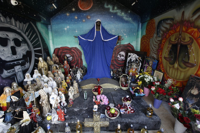 In this March 1, 2017 photo, images and statues of the Death Saint or “Santa Muerte” are displayed on a street altar on the outskirts Mexico City in the state of Mexico. As devotion expands, shrines to the Death Saint have been appearing in more public places. (Photo by Marco Ugarte/AP Photo)
