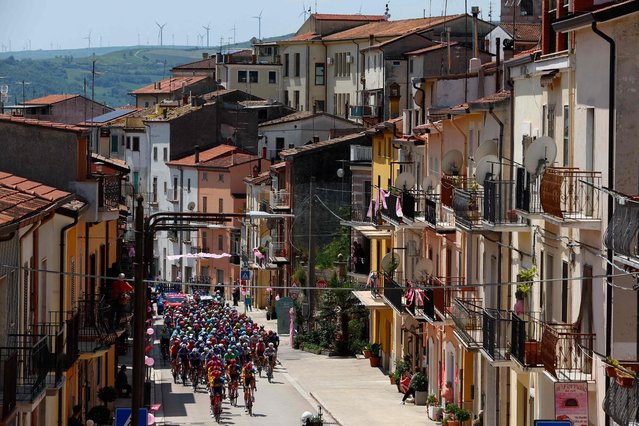 The pack rides in San Bartolomeo in Galdo during the 11th stage of the 107th Giro d'Italia cycling race, 207km between Foiano di Val Fortore and Franca Villa al Mare, on May 15, 2024. (Photo by Luca Bettini/AFP Photo)