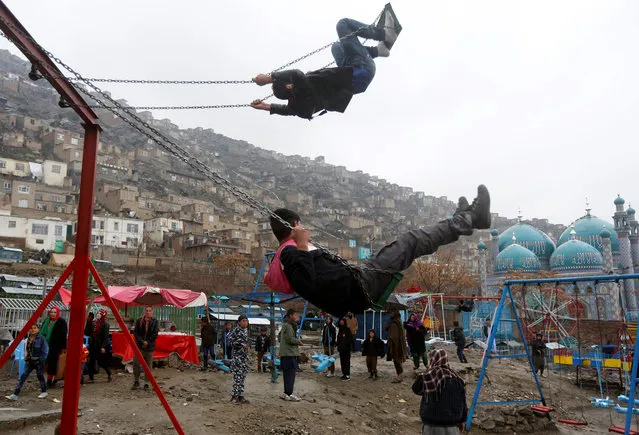 Afghan youth play on a swing during Newroz Day celebrations in Kabul, Afghanistan on March 21, 2017. (Photo by Omar Sobhani/Reuters)