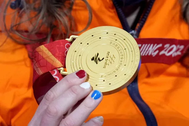Ireen Wust of the Netherlands holds her gold medal during a medal ceremony for the women's speedskating 1,500-meter at the 2022 Winter Olympics, Tuesday, February 8, 2022, in Beijing. (Photo by Natacha Pisarenko/AP Photo)