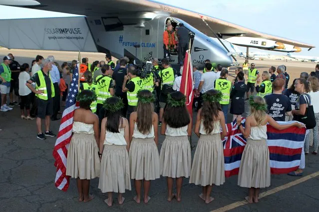 The Solar Impulse 2 airplane is greeted by hula dancers after it landed at Kalaeloa airport after flying non-stop from Nagoya, Japan in Kapolei, Hawaii, July 3, 2015. (Photo by Hugh Gentry/Reuters)