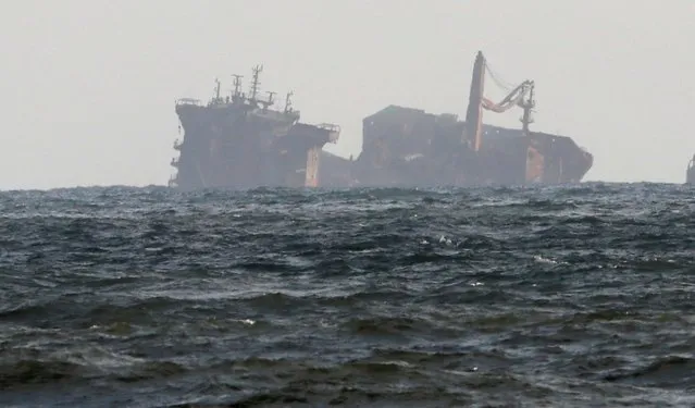 The MV X-Press Pearl vessel sinks while being towed into deep sea off the Colombo Harbour, as seen from a coastal area in Ja-Ela, in Sri Lanka on June 2, 2021. The cargo ship, carrying tonnes of chemicals, sank off Sri Lanka's west coast after a fire raged on deck for two weeks, in one of the country's worst-ever marine disasters. (Photo by Dinuka Liyanawatte/Reuters)