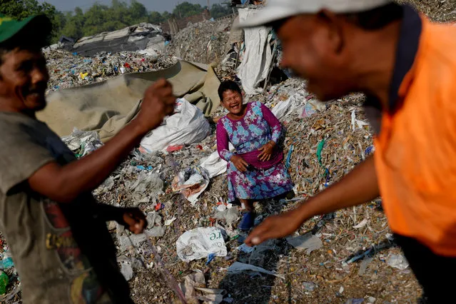 Sunarni laughs as her husband Salam jokes with his friend near a pile of rubbish at Bangun village in Mojokerto, East Java province, Indonesia, August 1, 2019. Salam said recycled rubbish paid for his children's schooling, and also bought a house for his family and livestock. “I have nine goats now”, said Salam, who works as a waste broker between villagers and a nearby paper factory and says his job is easier than farming. (Photo by Willy Kurniawan/Reuters)