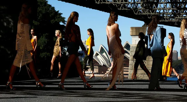 Models walk past the Sydney Opera House during the Manning Cartel show under the Sydney Harbour Bridge during Australian Fashion week, May 17, 2016. (Photo by Jason Reed/Reuters)