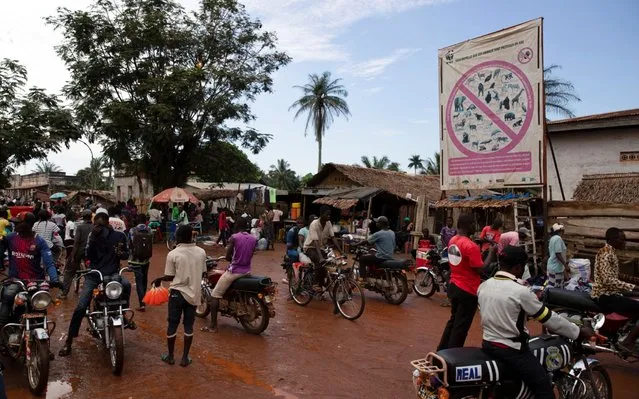 A WWF billboard listing protected species stands in front of a bushmeat market in Mbandaka, Democratic Republic of the Congo, October 19, 2018. (Photo by Thomas Nicolon/Reuters)