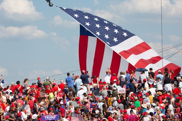 Trump supporters cheers as former US President and Republican presidential candidate Donald Trump speaks during a campaign event at Butler Farm Show Inc. in Butler, Pennsylvania, July 13, 2024. Donald Trump was hit in the ear in an apparent assassination attempt by a gunman at a campaign rally on Saturday, in a chaotic and shocking incident that will fuel fears of instability ahead of the 2024 US presidential election. (Photo by Rebecca Droke/AFP Photo)