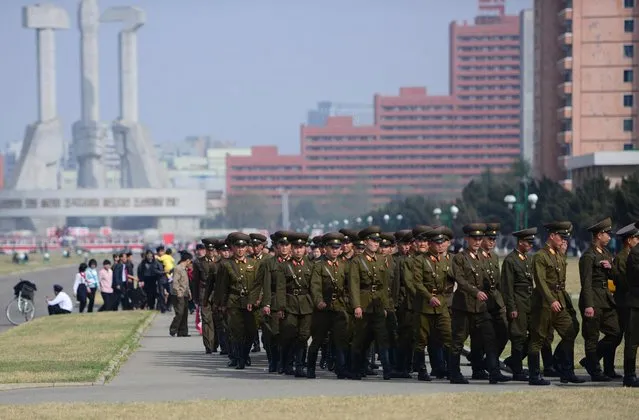 Soldiers march in Pyongyang with the Monument to Party Founding in the background. (Photo by Gavin John/Mediadrumworld.com)