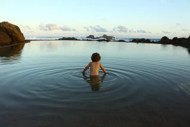 “Isabella takes a dip”. While everybody else is busy packing up at the end of the day, 20-month-old Isabella decides to take one last dip in the tidal pool in Southbroom. Photo location: Tidal pool, Southbroom, KwaZulu-Natal, South Africa. (Photo and caption by Jörn Dannheimer/National Geographic Photo Contest)