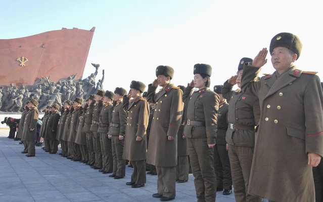 North Koreans pay their respects at the statues of former North Korean leaders Kim Il Sung and Kim Jong Il (unseen) on Lunar New Year in this February 19, 2015 photo released by North Korea's Korean Central News Agency (KCNA) in Pyongyang February 19, 2015. (Photo by Reuters/KCNA)