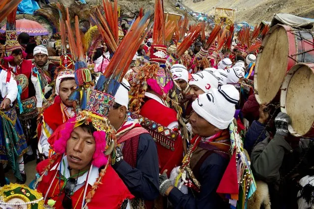 In this May 23, 2016 photo, pilgrims wait for the start of a procession to the Sanctuary of the Lord of the Qoyllur Rit’i, as part of the the syncretic festival of the same name, translated from the Quechua language as Snow Star, in the Sinakara Valley, in Peru's Cusco region. Tens of thousands of pilgrims crowd into the Andean valley, with dancers in multi-layered skirts and musicians with drums and flutes performing non-stop for the three-day festival. (Photo by Rodrigo Abd/AP Photo)