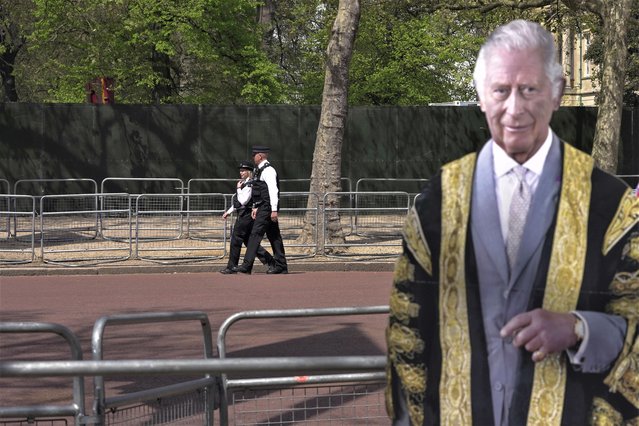 Police officers patrol besides a life-size cardboard of Britain's King Charles III in London, Wednesday, May 3, 2023. The Coronation of King Charles III will take place at Westminster Abbey on May 6. (Photo by Kin Cheung/AP Photo)