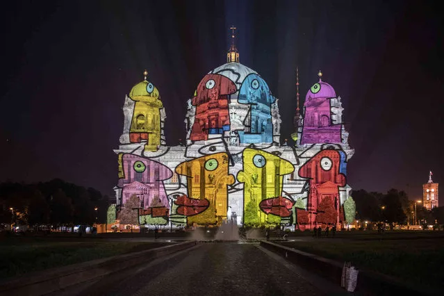 The Berlin Cathedral is illuminated during the rehearsal before the start of the 17th edition of the “Festival of Lights” in Berlin Thursday, September 2, 2021. (Photo by Paul Zinken/dpa via AP Photo)