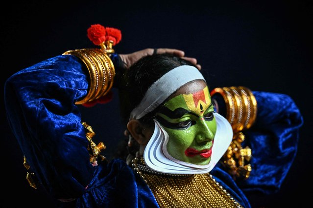 An artist prepares before performing Kathakali, a traditional form of classical Indian dance, during a show at a cultural festival in Chennai on September 12, 2024. (Photo by R.Satish Babu/AFP Photo)