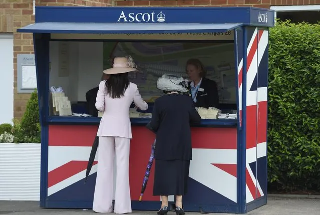 Britain Horse Racing, Royal Ascot, Ascot Racecourse on June 15, 2016. Racegoers buy race cards. (Photo by Toby Melville/Reuters/Livepic)