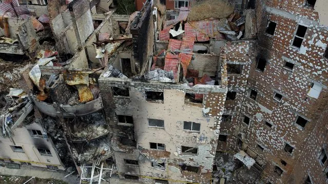 Damaged buildings ruined by attacks are seen in Irpin, on the outskirts Kyiv, Ukraine, Thursday, May 26, 2022. (Photo by Natacha Pisarenko/AP Photo)