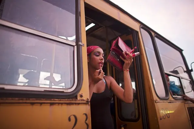 Dancer Karla Enriques, 20, puts make-up before performing at a carnival parade in Havana, Cuba August 7, 2015. (Photo by Alexandre Meneghini/Reuters)