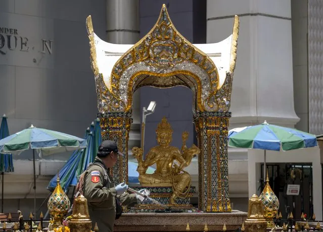 An expert cleans an altar with a statue of Hindu god Brahma at the Erawan shrine, the site of a deadly blast, in central Bangkok, Thailand, August 18, 2015. (Photo by Athit Perawongmetha/Reuters)