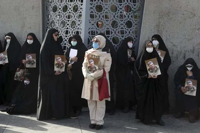 Mourners hold posters of Iran's Revolutionary Guard Col. Hassan Sayyad Khodaei who was killed on Sunday, in his funeral ceremony in Tehran, Iran, Tuesday, May 24, 2022. Iran's hard-line President Ebrahim Raisi vowed revenge on Monday over the killing of Sayyad Khodaei who was shot at his car by two assailants outside his home in Tehran, a still-mysterious attack on the country's powerful paramilitary force. (Photo by Vahid Salemi/AP Photo)