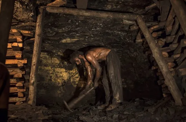 Zamurud Khan breaks coal at a mine in Choa Saidan Shah, Punjab province, April 29, 2014. (Photo by Sara Farid/Reuters)