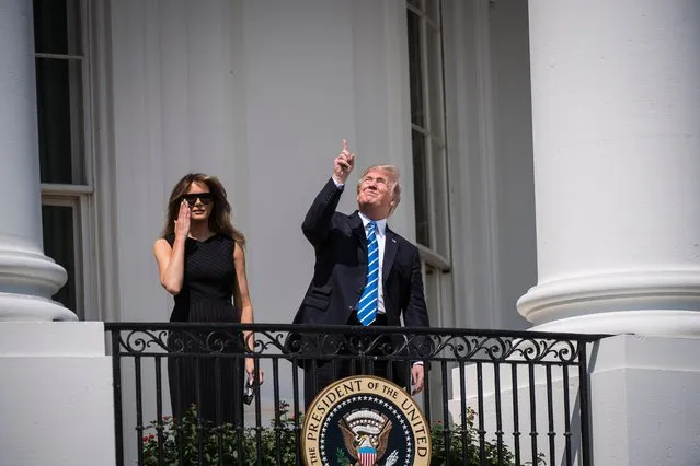 President Trump looks up toward the eclipse without glasses, with first lady Melania Trump by his side, from a balcony at the White House in Washington, US on August 21, 2017. (Photo by Jabin Botsford/The Washington Post)