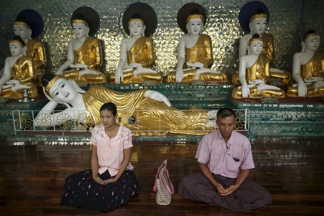 A woman and man meditate in Shwedagon pagoda in Yangon August 25, 2015. (Photo by Soe Zeya Tun/Reuters)