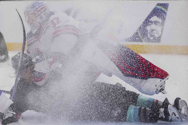 Seattle Kraken left wing Brandon Tanev collides with New York Rangers goaltender Jonathan Quick (32) after losing the puck during the second period of an NHL hockey game Sunday, November 17, 2024, in Seattle. (Photo by Lindsey Wasson/AP Photo)