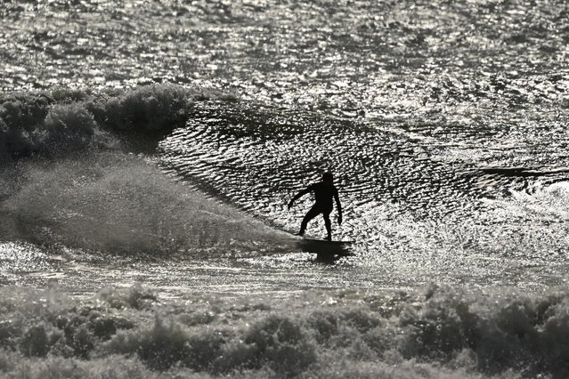 A surfer cuts up wave during a rough conditions at the world renowned surfing spot of Manu Bay, some six kilometres south of the coastal town of Raglan, New Zealand on September 25, 2024. (Photo by William West/AFP Photo)