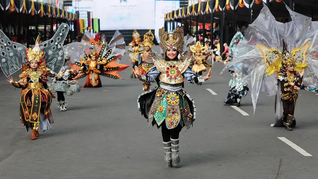 Models wear Borobudur costumes in the kids carnival during The 13th Jember Fashion Carnival 2014 on August 21, 2014 in Jember, Indonesia. The 13th Jember Fashion Carnival (JFC) 2014 theme is “Triangle, Dynamic in Harmony” and consists of ten parades which include Mahabharata, Tambora, Phoenix, Pine Forest, Apache, Borobudur, Flying Kite, Wild Deers, Stalagmite, and Chemistry. (Photo by Robertus Pudyanto/Getty Images)