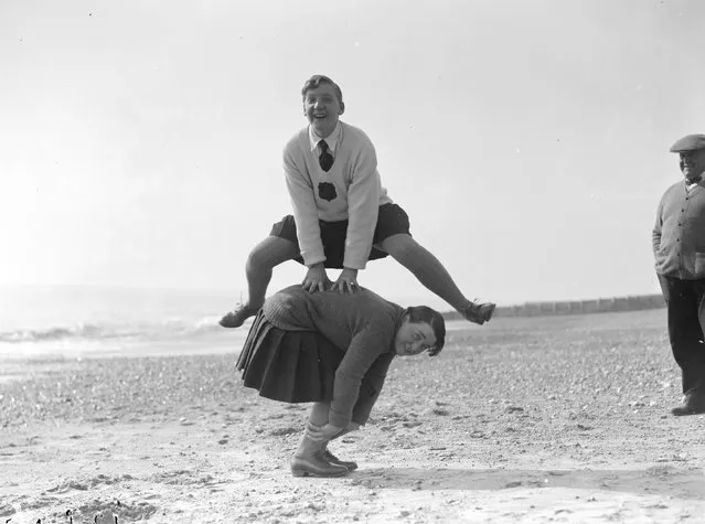 A couple of young women playing leap frog on the beach at Hove, March 1929.