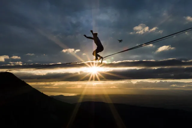 In this photo taken Friday, September 15, 2017, British professional slackliner Sarah Rixham performs during the Highline Extreme event on the top of the Moleson peak at 2000 meters above the sea level, in the Swiss Alps, near Fribourg, Switzerland. 25 of the world's best slackliners compete until Sept. 17, on six different lines ranging from 45 meters to 350 meters. (Photo by Valentin Flauraud/Keystone via AP Photo)